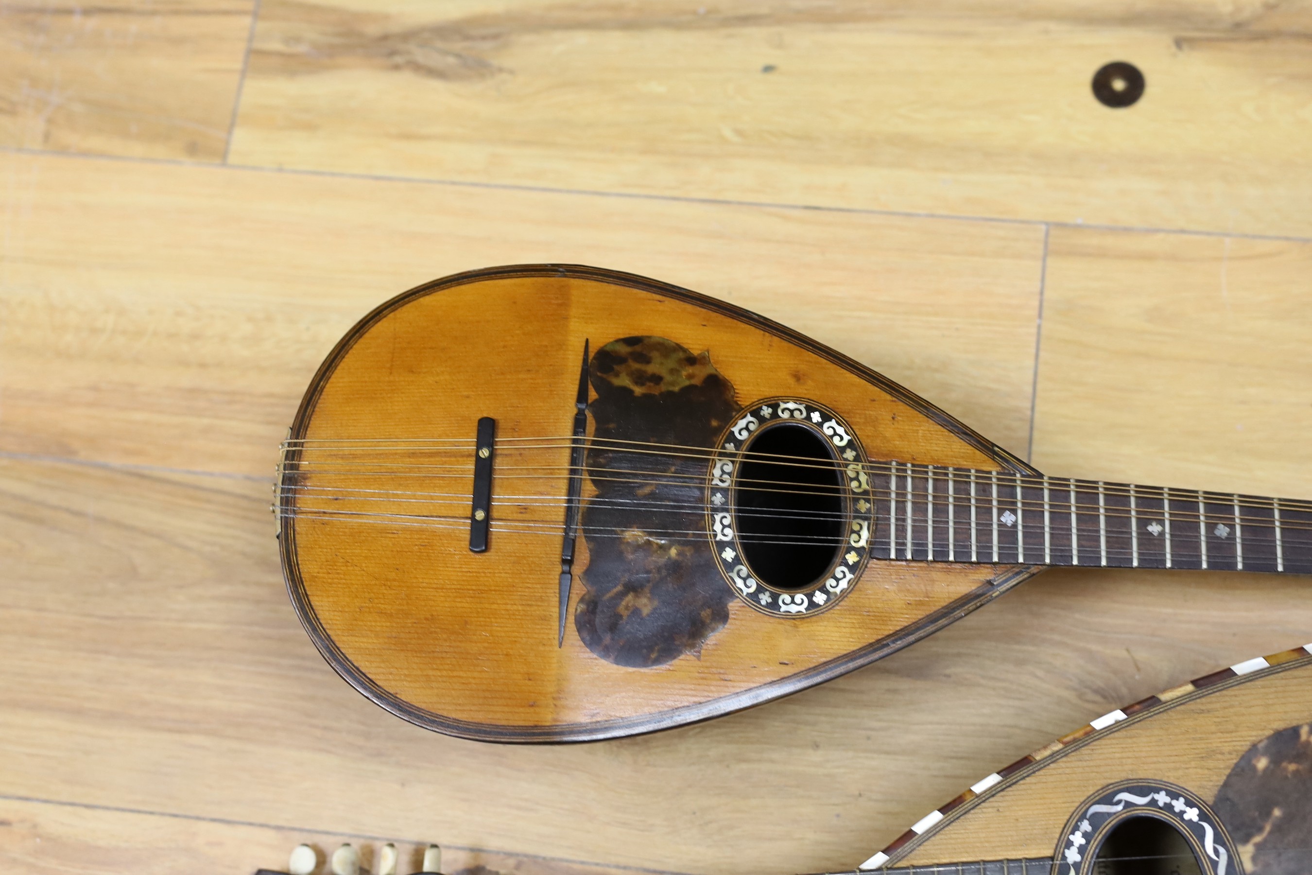 Two mandolins, with mother of pearl and tortoiseshell inlay, 57ms long, bone mounts